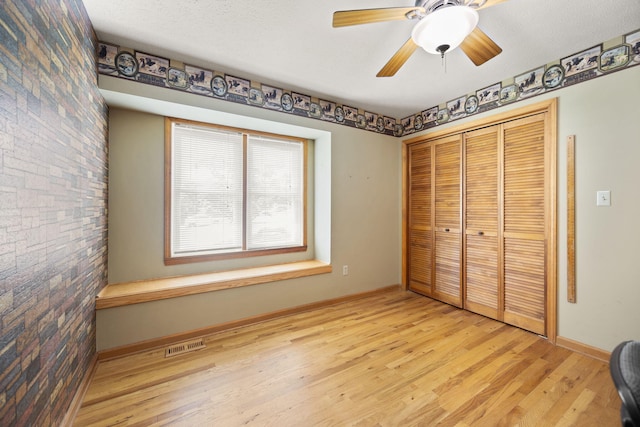 1636 Green Hill Estates Rd, Monticello, KY 42633 - unfurnished bedroom featuring wood finished floors, baseboards, a closet, and a ceiling fan