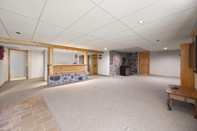 1636 Green Hill Estates Rd, Monticello, KY 42633 - finished below grade area with carpet floors, a wood stove, a paneled ceiling, baseboards, and recessed lighting