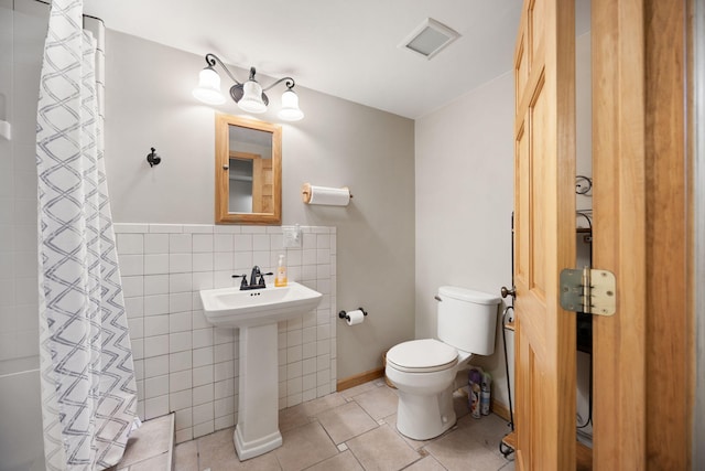 1636 Green Hill Estates Rd, Monticello, KY 42633 - bathroom with toilet, tile walls, curtained shower, tile patterned floors, and a sink