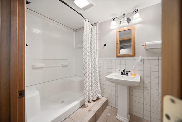 1636 Green Hill Estates Rd, Monticello, KY 42633 - full bathroom with tile walls, a shower with shower curtain, tile patterned floors, a sink, and wainscoting