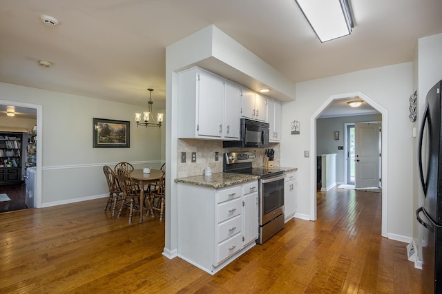 301 Atwood Dr, Lexington, KY 40515 - kitchen featuring stainless steel range with electric stovetop, black microwave, freestanding refrigerator, hardwood / wood-style flooring, and white cabinetry
