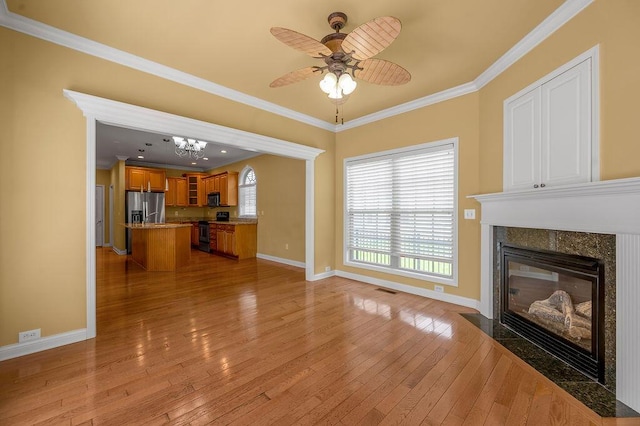 3765 Ridge View Way, Lexington, KY 40509 - unfurnished living room featuring baseboards, light wood-style flooring, ornamental molding, a premium fireplace, and ceiling fan