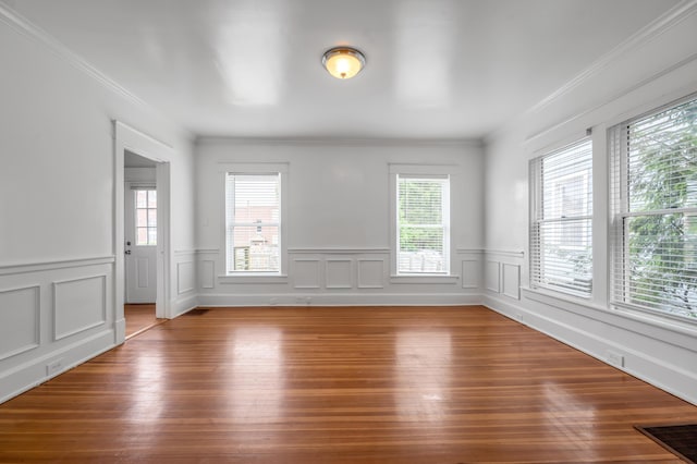 109 N Ashland Ave, Lexington, KY 40502 - spare room featuring plenty of natural light, wood finished floors, wainscoting, and ornamental molding