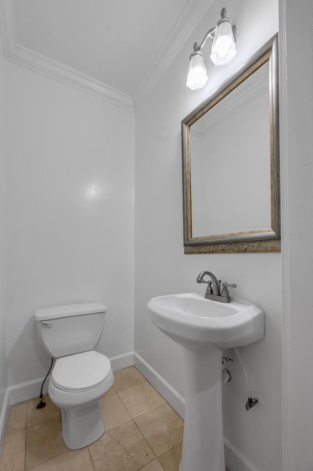 109 N Ashland Ave, Lexington, KY 40502 - half bathroom featuring crown molding, toilet, baseboards, and a sink