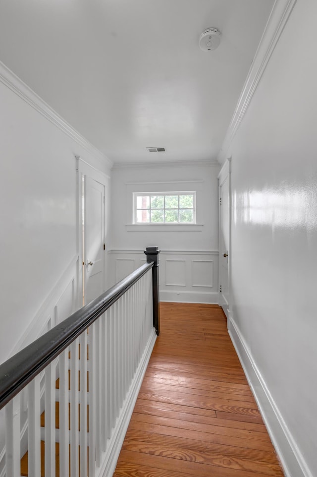 109 N Ashland Ave, Lexington, KY 40502 - hallway with crown molding, an upstairs landing, light wood-type flooring, and a decorative wall