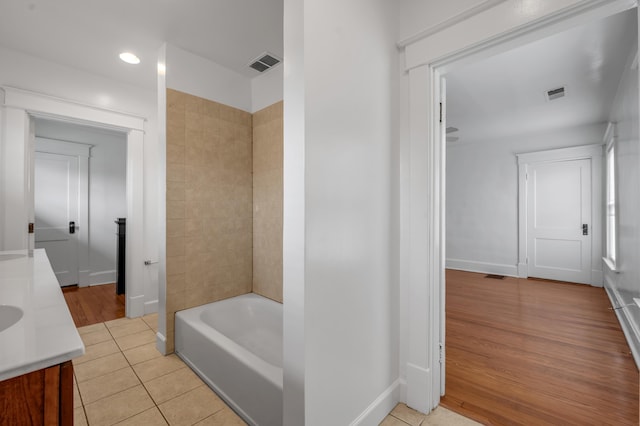 109 N Ashland Ave, Lexington, KY 40502 - bathroom featuring vanity, tile patterned floors, baseboards, recessed lighting, and shower / tub combination