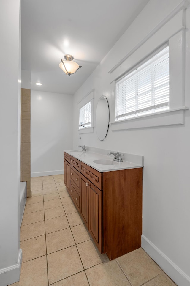 109 N Ashland Ave, Lexington, KY 40502 - full bath featuring tile patterned flooring, double vanity, a tub, and baseboards