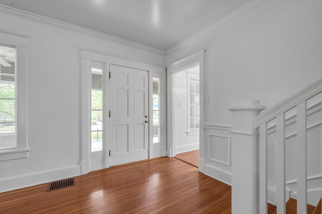 109 N Ashland Ave, Lexington, KY 40502 - foyer featuring wood-type flooring, ornamental molding, and a decorative wall