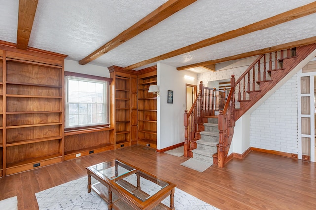 645 Raven Dr, Frankfort, KY 40601 - unfurnished living room with baseboards, stairway, a textured ceiling, wood finished floors, and beam ceiling