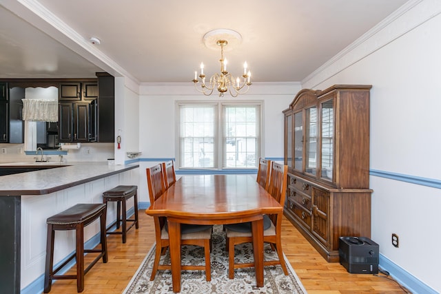 645 Raven Dr, Frankfort, KY 40601 - dining area featuring a chandelier, light wood-type flooring, and crown molding