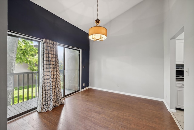 750 Shaker Dr Unit 907, Lexington, KY 40504 - unfurnished dining area featuring hardwood / wood-style floors, baseboards, and a high ceiling