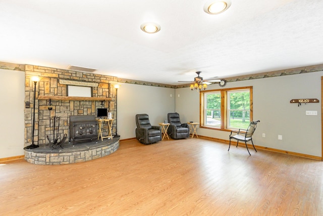 2200 Kays Branch Rd, Owenton, KY 40359 - living area featuring wood finished floors, baseboards, ceiling fan, and a wood stove