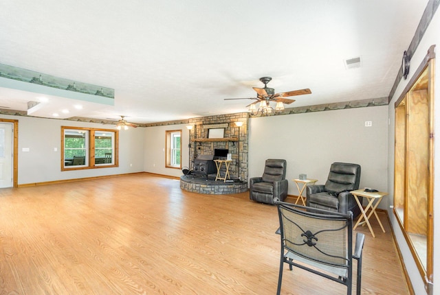 2200 Kays Branch Rd, Owenton, KY 40359 - living area featuring ceiling fan, light wood-type flooring, baseboards, and a wood stove