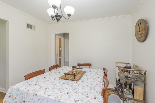 235 W Vista St, Lexington, KY 40503 - dining space with crown molding, a chandelier, wood finished floors, and baseboards