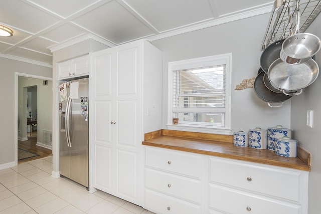 235 W Vista St, Lexington, KY 40503 - kitchen with stainless steel refrigerator with ice dispenser, butcher block counters, light tile patterned floors, white cabinetry, and baseboards