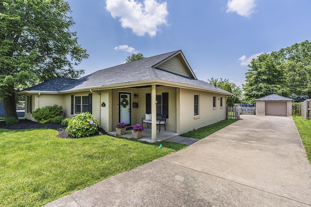 235 W Vista St, Lexington, KY 40503 - view of front of home with a porch, an outbuilding, a detached garage, roof with shingles, and concrete driveway