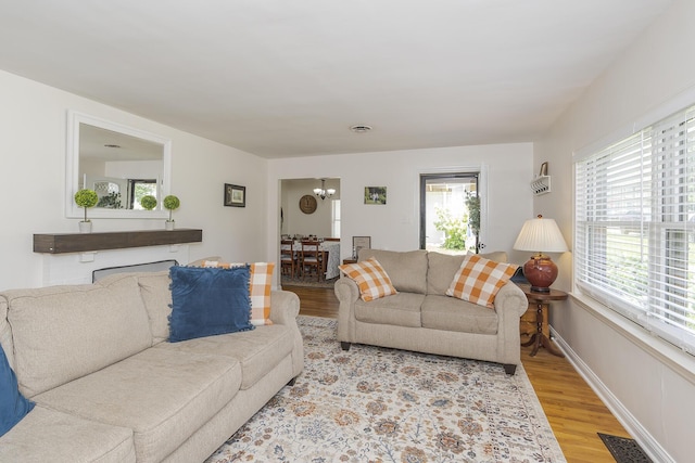 235 W Vista St, Lexington, KY 40503 - living room featuring light wood-style flooring, healthy amount of natural light, a chandelier, and baseboards