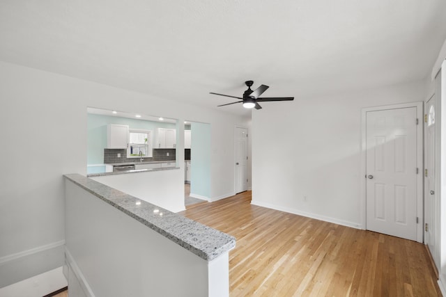 289 Mulberry Ct, Lexington, KY 40509 - unfurnished living room featuring ceiling fan, baseboards, and light wood-style flooring