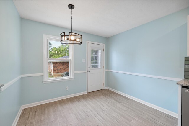 289 Mulberry Ct, Lexington, KY 40509 - unfurnished dining area featuring light wood-style floors, baseboards, and a chandelier