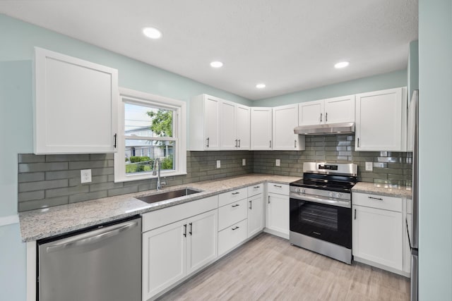 289 Mulberry Ct, Lexington, KY 40509 - kitchen with stainless steel appliances, under cabinet range hood, a sink, white cabinets, and recessed lighting
