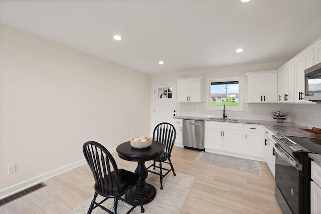 877 Hideaway Dr, Somerset, KY 42503 - kitchen with appliances with stainless steel finishes, a sink, decorative backsplash, recessed lighting, and light stone counters