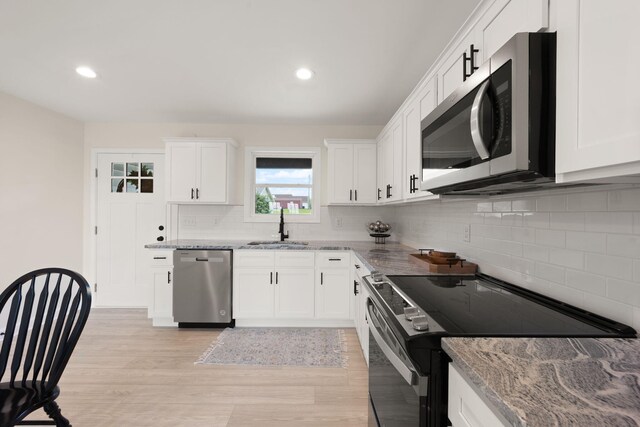 877 Hideaway Dr, Somerset, KY 42503 - kitchen featuring appliances with stainless steel finishes, a sink, light stone countertops, backsplash, and recessed lighting