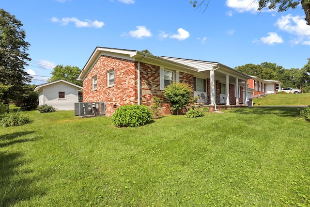 60 Parsons St, Corbin, KY 40701 - view of property exterior featuring brick siding, covered porch, a lawn, and cooling unit