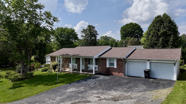 60 Parsons St, Corbin, KY 40701 - ranch-style house with a garage, covered porch, asphalt driveway, a front lawn, and brick siding