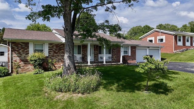 60 Parsons St, Corbin, KY 40701 - ranch-style home with an attached garage, a porch, brick siding, and driveway