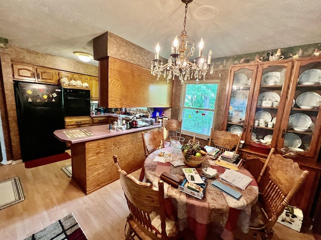 2369 Big Cave Rd, Mount Vernon, KY 40456 - dining space featuring a chandelier, light wood-style flooring, and a textured ceiling