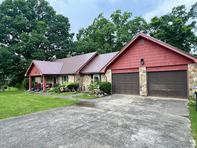 2369 Big Cave Rd, Mount Vernon, KY 40456 - ranch-style home featuring stone siding, driveway, a front lawn, an attached garage, and metal roof