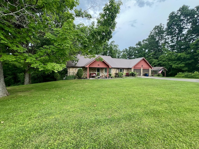2369 Big Cave Rd, Mount Vernon, KY 40456 - ranch-style house with stone siding, a garage, a front lawn, and metal roof