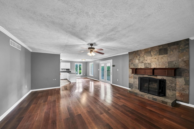 399 Stonecrest Rd, Winchester, KY 40391 - unfurnished living room featuring wood finished floors, a tiled fireplace, baseboards, ornamental molding, and a ceiling fan
