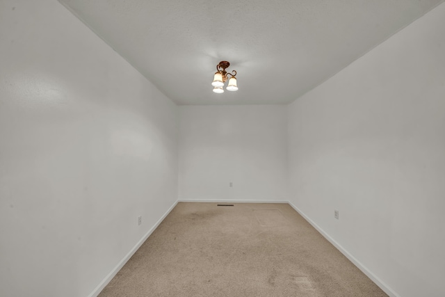 399 Stonecrest Rd, Winchester, KY 40391 - empty room with light colored carpet, baseboards, and a chandelier