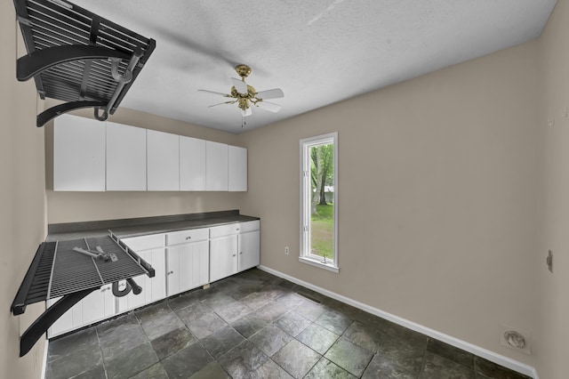 399 Stonecrest Rd, Winchester, KY 40391 - washroom with baseboards, a ceiling fan, and dark stone finish floors