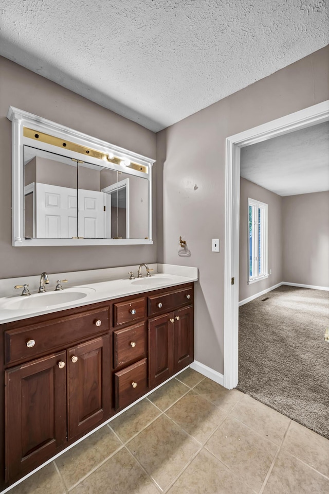 399 Stonecrest Rd, Winchester, KY 40391 - bathroom with double vanity, a textured ceiling, tile patterned flooring, and baseboards