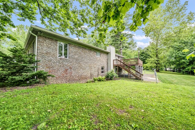 399 Stonecrest Rd, Winchester, KY 40391 - view of side of home featuring stairway, stone siding, a deck, a yard, and a chimney