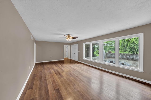 399 Stonecrest Rd, Winchester, KY 40391 - empty room with a textured ceiling, wood finished floors, baseboards, and a ceiling fan