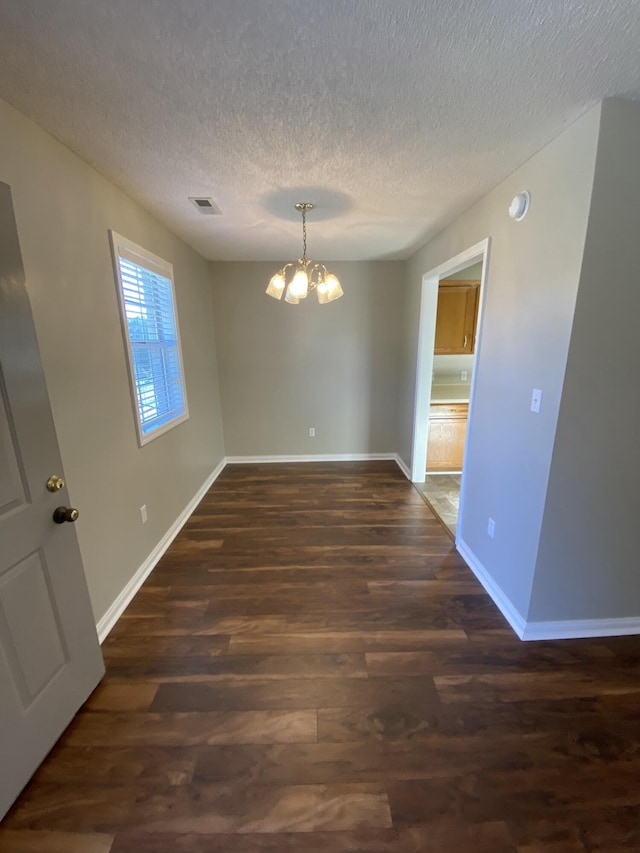 4019 Jodis Way, Somerset, KY 42503 - spare room featuring a chandelier, dark wood-type flooring, baseboards, and a textured ceiling