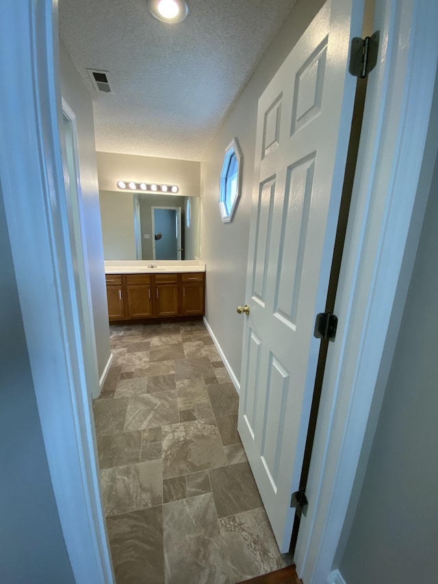 4019 Jodis Way, Somerset, KY 42503 - bathroom featuring vanity, baseboards, and a textured ceiling