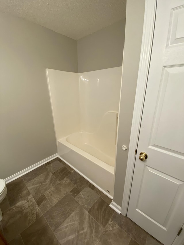 4019 Jodis Way, Somerset, KY 42503 - bathroom with toilet, baseboards, a textured ceiling, and shower / tub combination