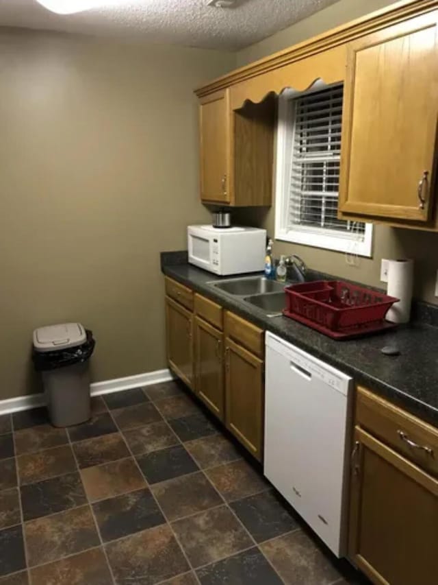 4019 Jodis Way, Somerset, KY 42503 - kitchen with white appliances, a sink, baseboards, and dark countertops