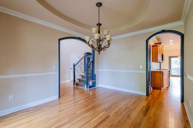 2433 San Milano Pl, Lexington, KY 40509 - empty room featuring a chandelier, arched walkways, light wood finished floors, stairs, and baseboards