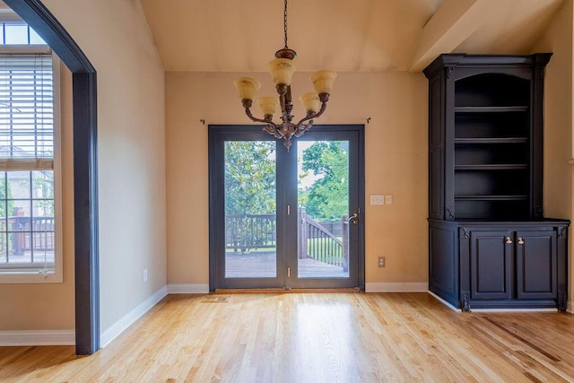 2433 San Milano Pl, Lexington, KY 40509 - unfurnished dining area with a chandelier, light wood-type flooring, baseboards, and lofted ceiling