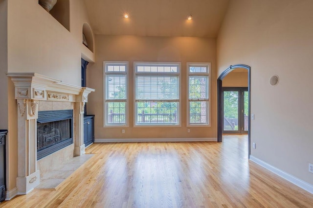 2433 San Milano Pl, Lexington, KY 40509 - unfurnished living room with a fireplace, light wood-style flooring, and baseboards