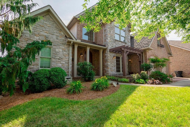 2433 San Milano Pl, Lexington, KY 40509 - view of front of home with stone siding, a pergola, a front yard, and a garage