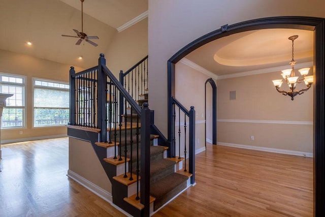 2433 San Milano Pl, Lexington, KY 40509 - stairs featuring arched walkways, wood finished floors, ceiling fan, a chandelier, and ornamental molding