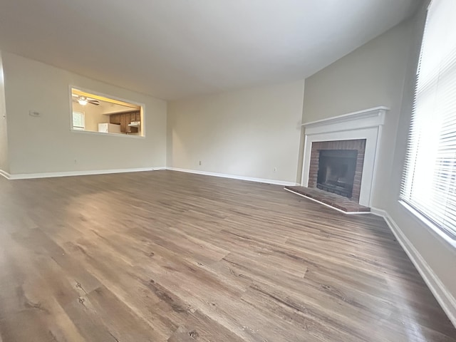 3154 High Ridge Dr, Lexington, KY 40517 - unfurnished living room with wood finished floors, a fireplace, and baseboards