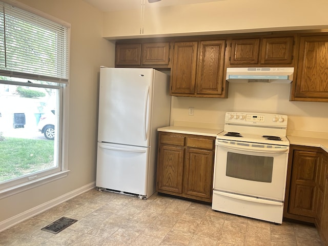 3154 High Ridge Dr, Lexington, KY 40517 - kitchen with white appliances, under cabinet range hood, light countertops, and brown cabinets