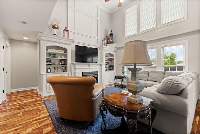 398 Arden Dr, London, KY 40741 - living area with light wood-style floors, a high ceiling, crown molding, a ceiling fan, and a fireplace